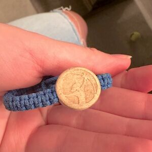 Blue bracelet with wood charm.